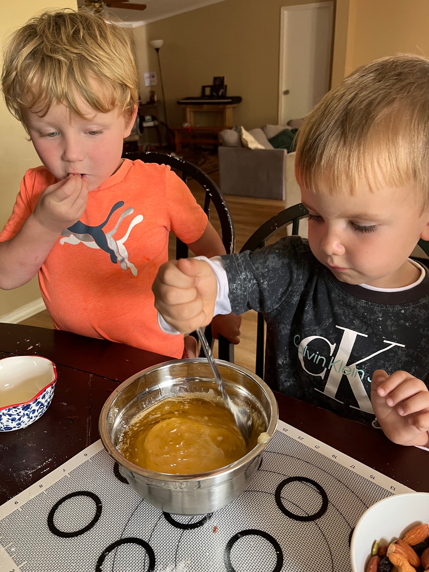 Children stirring a mixing bowl